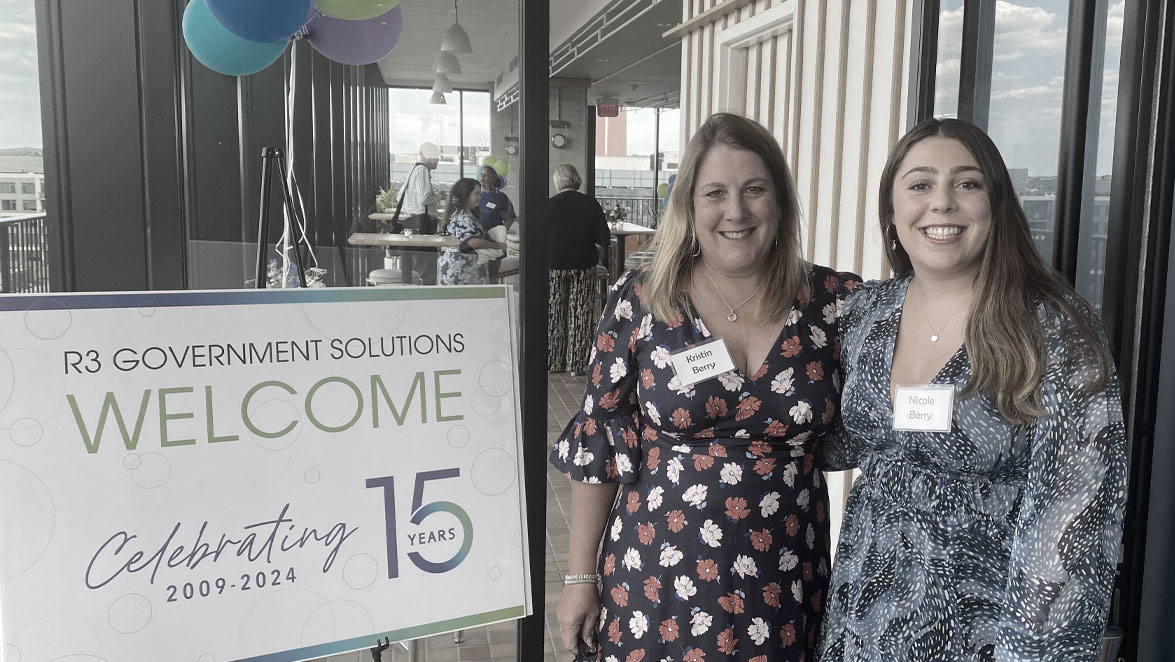 photo two women next to welcome sign