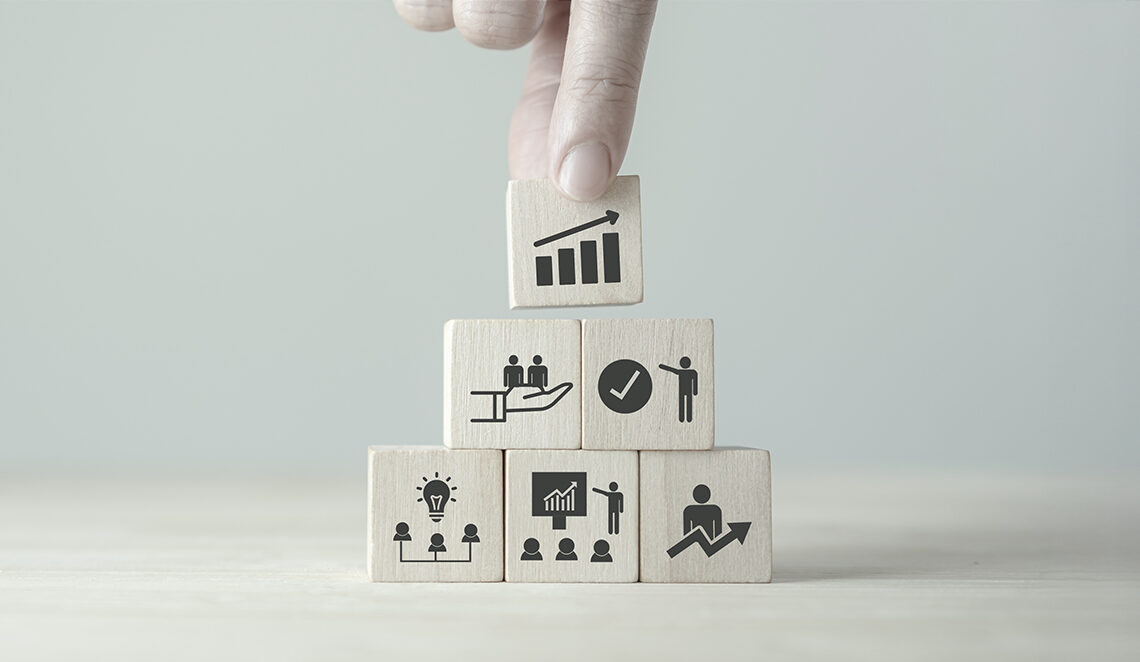 stock photo hand stacking blocks with icons